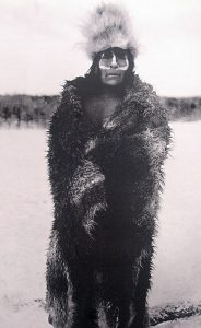 Selknam man with face paint and skins